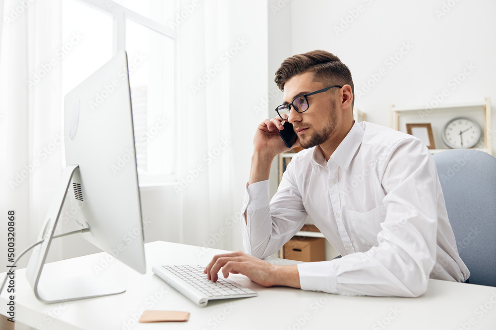 handsome businessman wearing glasses sits at a desk office worked executive handsome businessman wearing glasses sits at a desk office worked executive