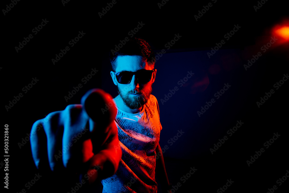 Man point his finger at you in dark background Man point his finger at you in dark background