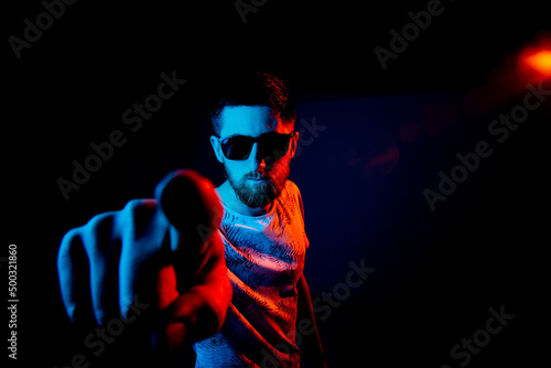 Man point his finger at you in dark background