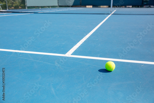 Tennis ball on empty court © Josh