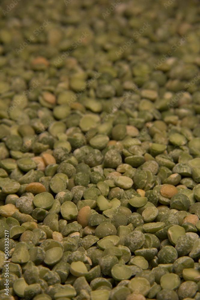 Background of green pea groats. Close up. Vertical. Background of green pea groats. Close up. Vertical.