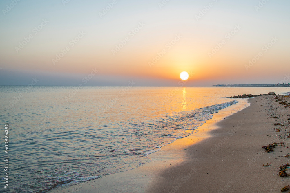 Landscape of sunrise, sun, sky and beach on the shores of the Red Sea in Hurghada, Egypt