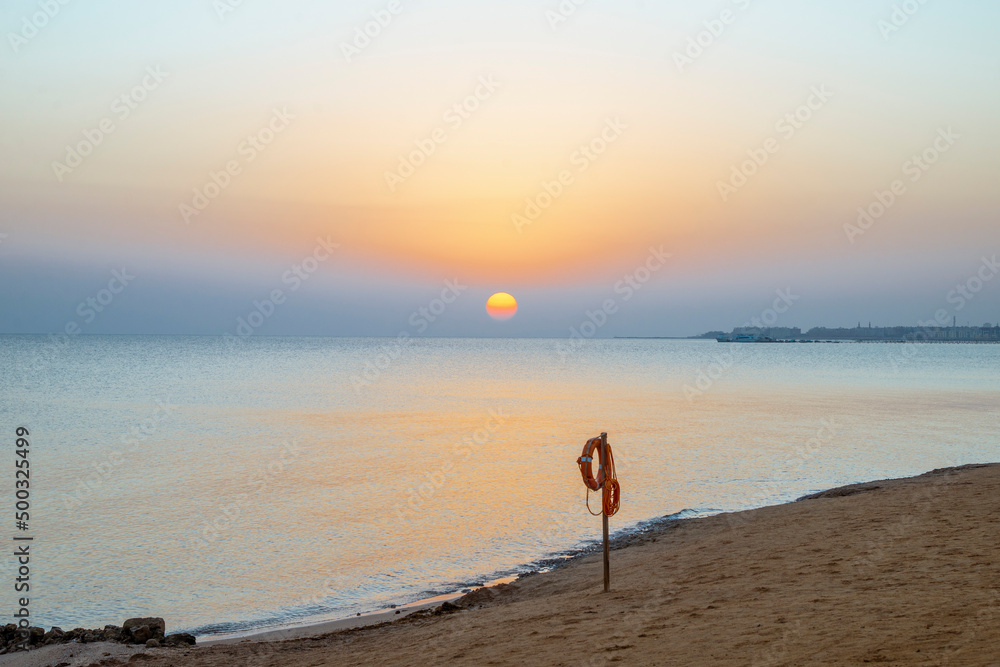 Obraz premium Landscape of sunrise, sun, sky and beach on the shores of the Red Sea in Hurghada, Egypt
