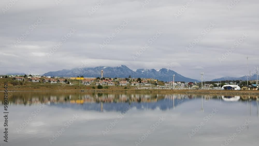 Panorama view of Ushuaia city in Tierra del Fuego, Patagonia Argentina. View of the houses and buildings at the sea shore with the Andes mountains in the background. 