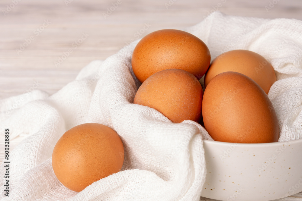 chicken eggs in a white cup with a cotton napkin, close-up chicken eggs in a white cup with a cotton napkin, close-up