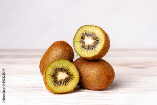 kiwi slices on a white wooden table, healthy food, fruit diet