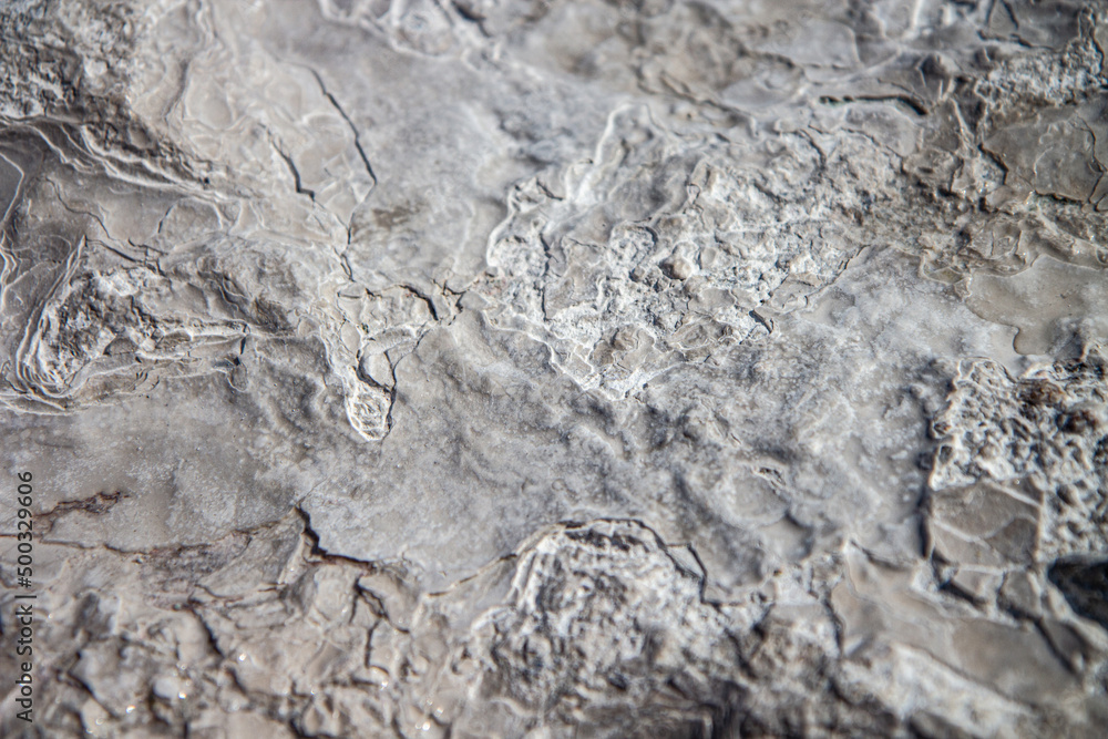 Fototapeta premium Stone texture covered with calcium deposits. Pamukale texture. Grey back.