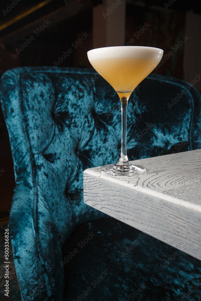 Homemade Pisco sour cocktail. Whiskey Sour in Coupe Glass with ice on gray background. Overhead view, copy space. Advertising for cafe. Bar menu.