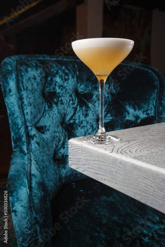 Obraz na płótnie Homemade Pisco sour cocktail. Whiskey Sour in Coupe Glass with ice on gray background. Overhead view, copy space. Advertising for cafe. Bar menu. w salonie