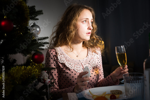 Photography Sad woman is bored with champagne in New Year night