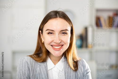 Closeup portrait of successful happy young business woman in office and looking at camera Free Download Closeup portrait of successful happy young business woman in office and looking at camera - GFXLoad