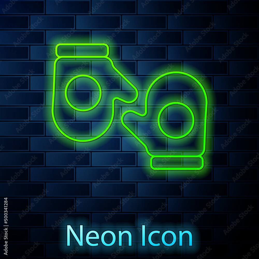 Glowing neon line Christmas mitten icon isolated on brick wall background. Merry Christmas and Happy New Year. Vector Glowing neon line Christmas mitten icon isolated on brick wall background. Merry Christmas and Happy New Year. Vector