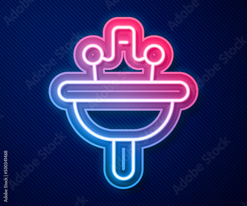 Glowing neon line Washbasin with water tap icon isolated on blue background. Vector