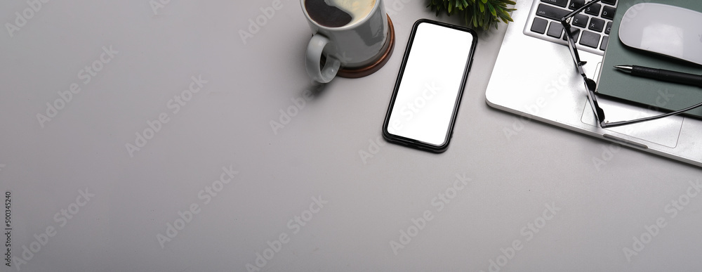 Modern workplace with smart phone, laptop computer, coffee cup, eyeglasses and notebook. Modern workplace with smart phone, laptop computer, coffee cup, eyeglasses and notebook.