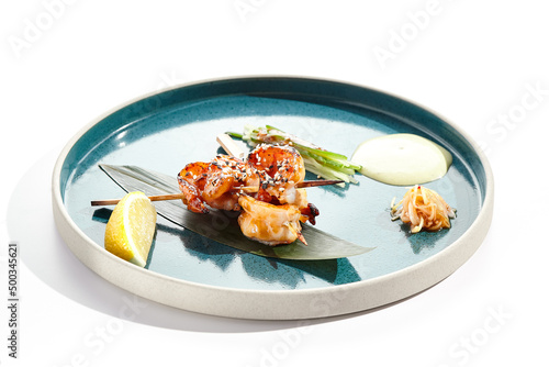 Japanese yakitori with skewers shrimp and teriyaki sauce. Grilled prawns  on bamboo stick in Japanese style. Bbq menu for asian restaurant. Prawn Yakitori on white background.