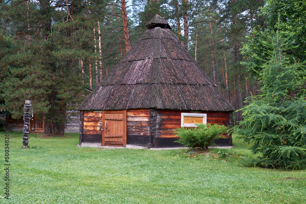 Ail. Altai folk national dwelling with wooden walls and bark-covered roof