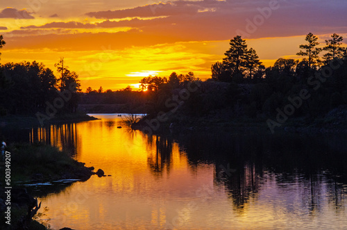 Sunset over a forest lake
 photo