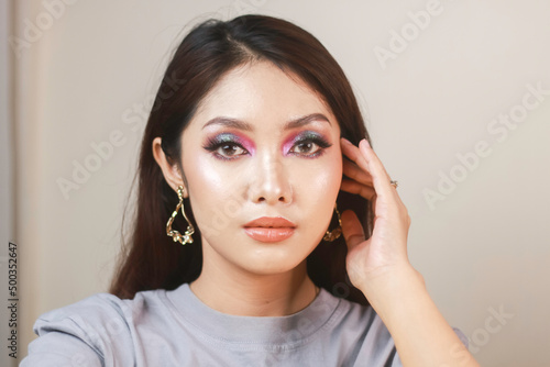 Conceptual beauty portrait of a beautiful young woman with colorful eyeshadow