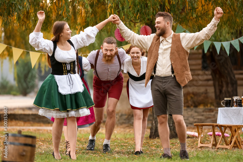 Drunk people dancing and celebrating Octoberfest outdoors