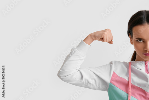 Strong young woman on light...