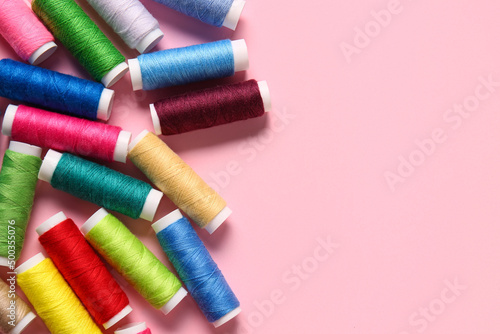 Thread spools on pink background