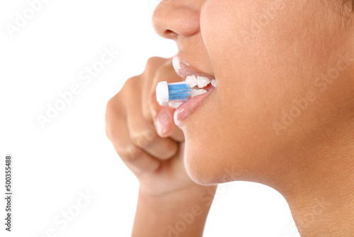 African-American teenage girl brushing her teeth on white background, closeup
