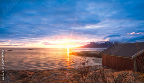 Canvastavla Red nordic style boathouse overlooking sunset, fjord and mountains