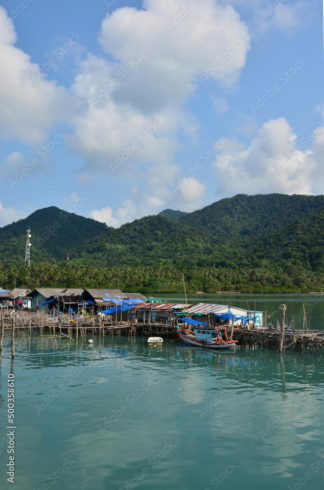 View landscape seascape and fishing boat ship floating in water sea waiting catch fish and marine life in ocean at fishing village house home on Koh Chang island at Gulf of Thailand in Trat, Thailand