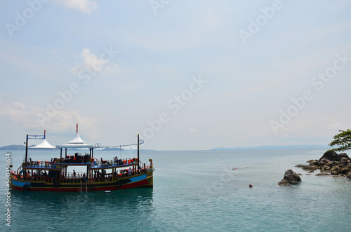 Ship cruise or boat tour stop for send receive thai people and foreign travelers travel visit rest relax and play swimming water in sea ocean in Gulf of Thailand at Koh Chang island in Trat, Thailand