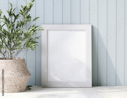 Foto 3D render, a white blank wooden picture frame on cottage style wooden pastel blue panel wall with  decor houseplants in rattan basket, on the table
