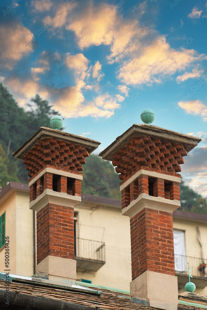 chimneys on the roof against the background of clouds