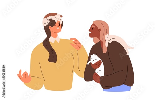 Happy pet owners with cats, holding cute kitties and talking. Women friends w...