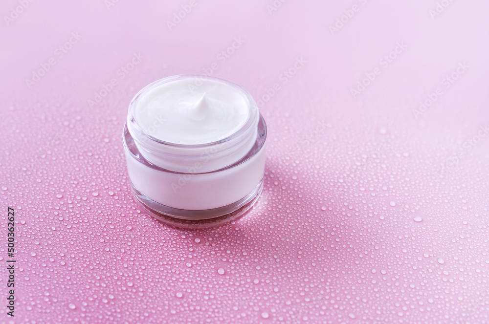 cream on pink background with water drops cream on pink background with water drops