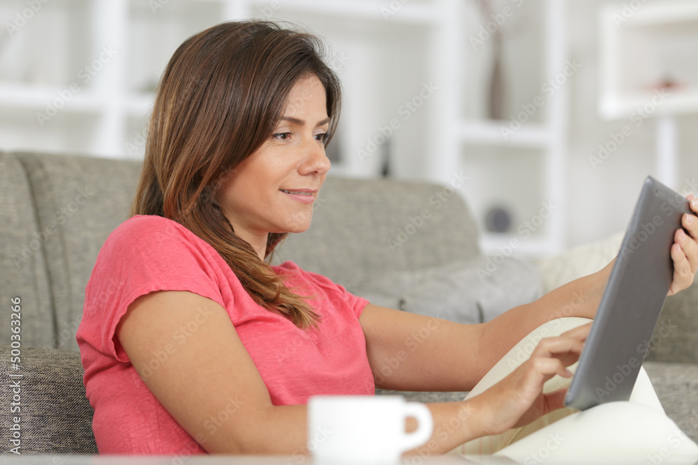 happy woman with tablet pc at home