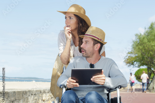 disabled man with his wife on the beach