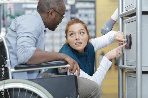 woman assisting man in wheelchair