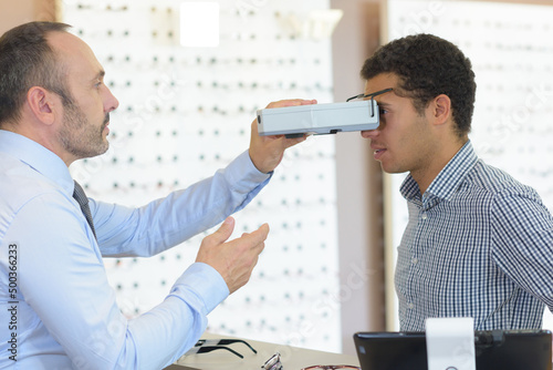 worker measuring clients pupillary distance photo