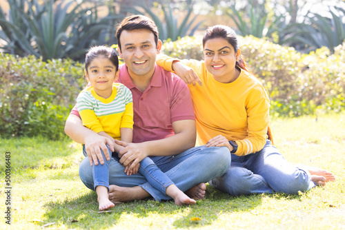 Portrait of happy Indian family spending leisure time at park