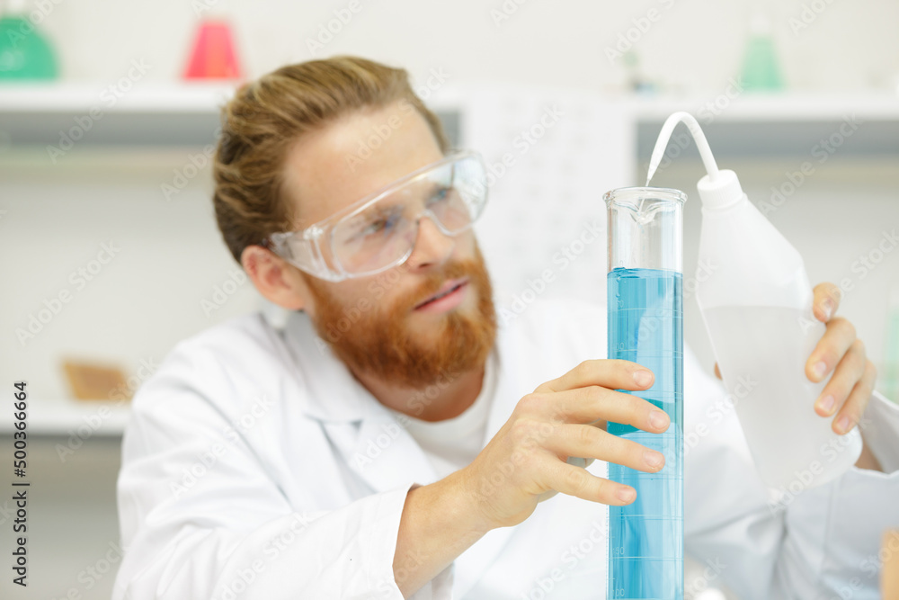 man doing an experiment in the lab man doing an experiment in the lab