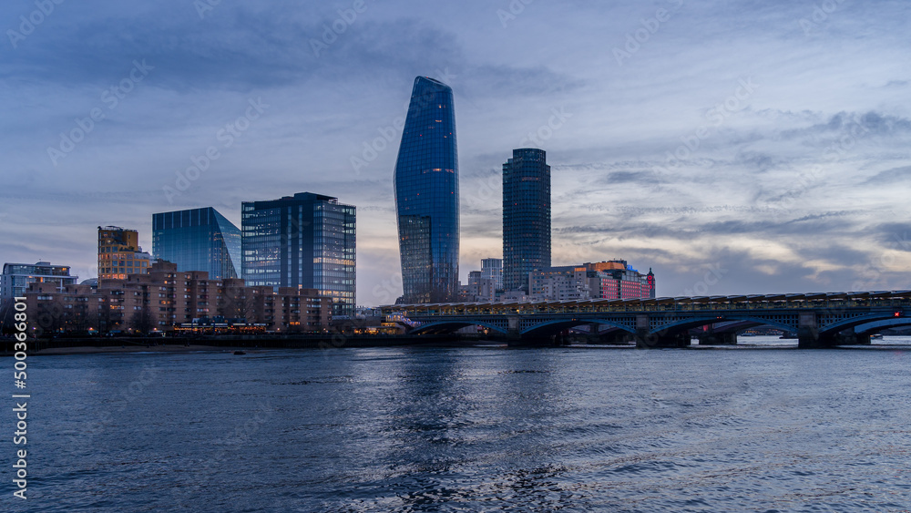 A view in the evening on the Thames and London high-rise buildings.