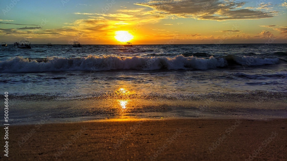 sunrise on the beach with waves and boats, and a beautiful sky sunrise on the beach with waves and boats, and a beautiful sky