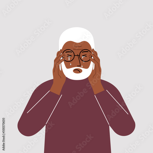 Upset man cries and holds his head with his hands. The concept of resentment, pain and depression.
