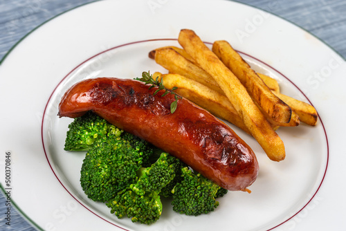 Sausage from Montb liard - French Charcuterie broccoli and fries photo