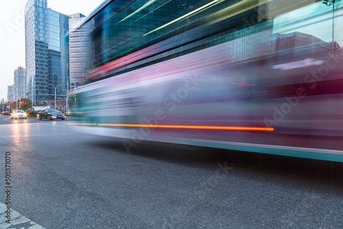 urban city road with motion bus at twilight, china.