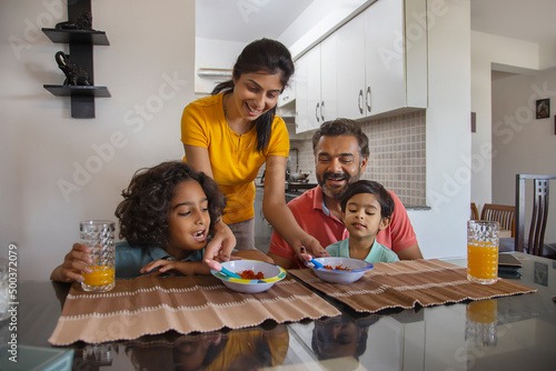 Portrait of a nuclear family at breakfast table in living room