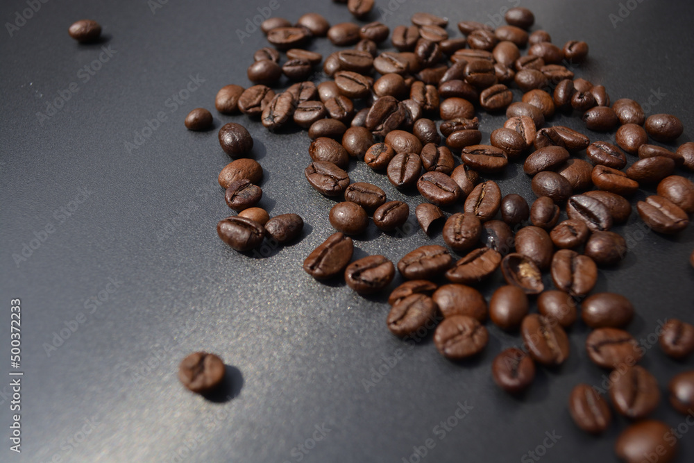 Coffee Beans spilled on a shiny grey background Coffee Beans spilled on a shiny grey background
