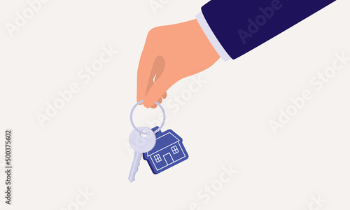 Close-Up View Of A Businessman’s Hand Holding House Key With Keychain.