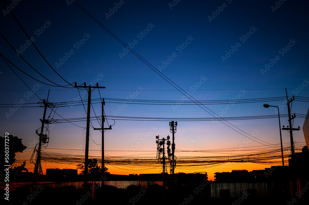 silhouette eletrical cable on electricity pole at  twilight dawn
