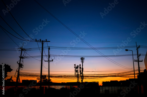 silhouette eletrical cable on electricity pole at twilight dawn