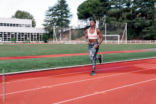Young black athlete sprinter running © santypan
